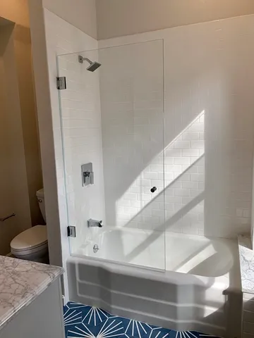 a bathroom with a bathtub and a shower