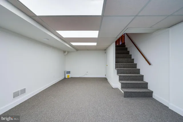 a view of an empty room with stairs