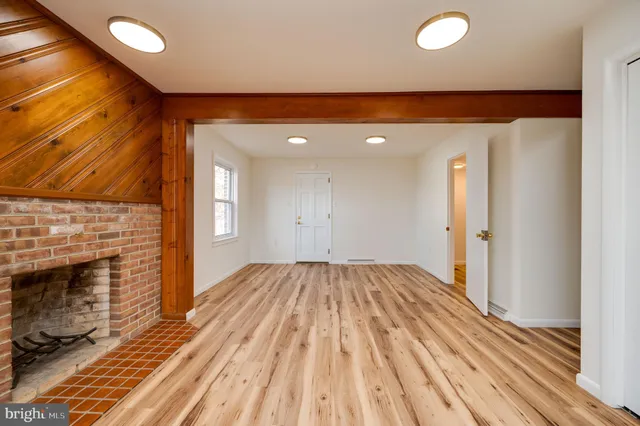 a view of livingroom with fireplace and wooden floor