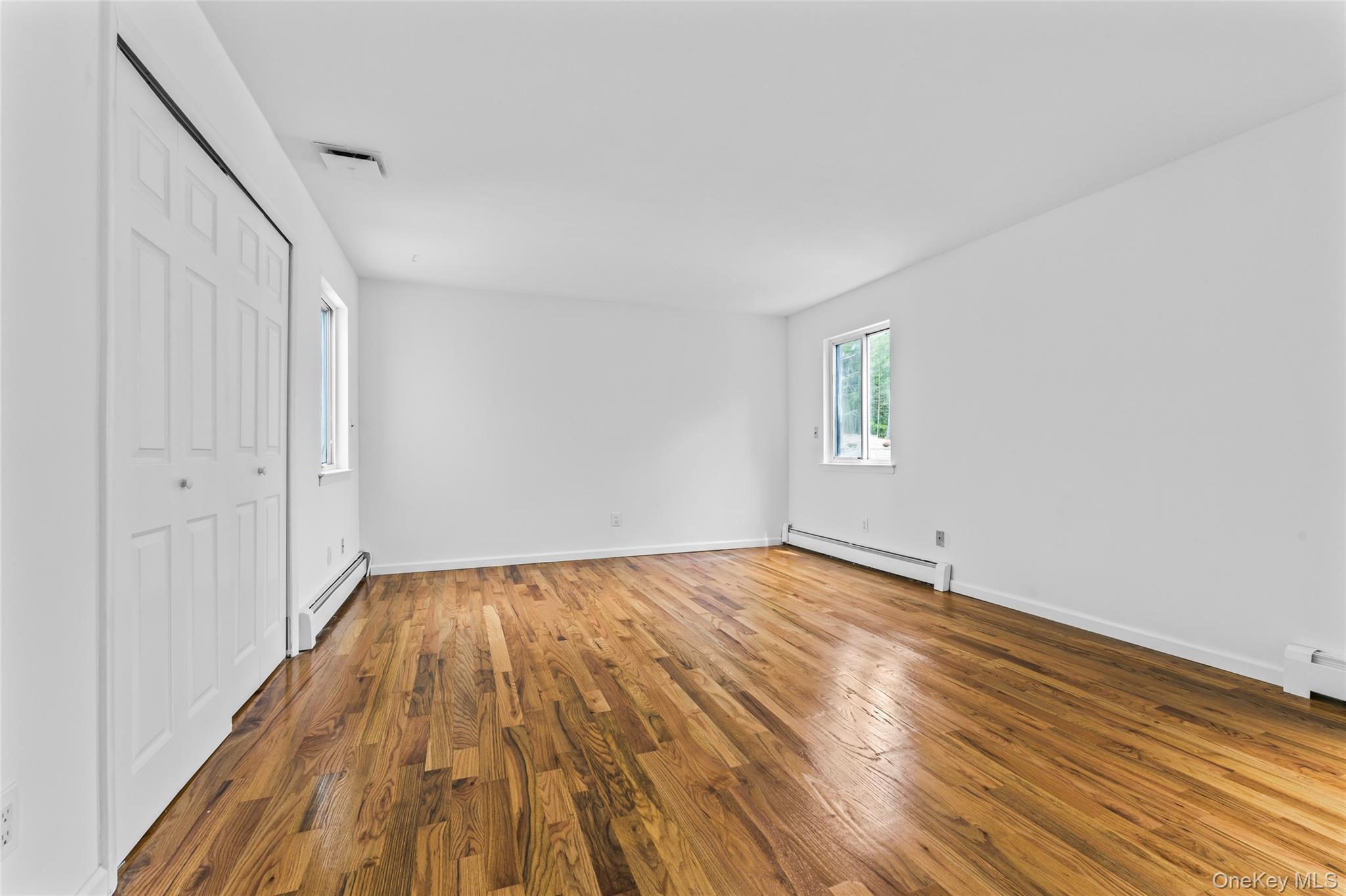 126 Bagatelle Road Melville, NY 11747 - Photo 31 of 50 a view of an empty room and wooden floor