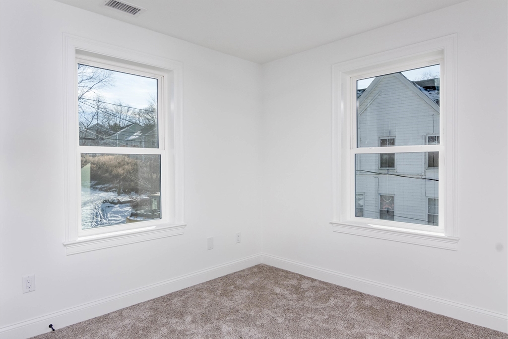 3 Crest Avenue Worcester, MA 01607 - Photo 26 of 34 an empty room with a window and wooden floor