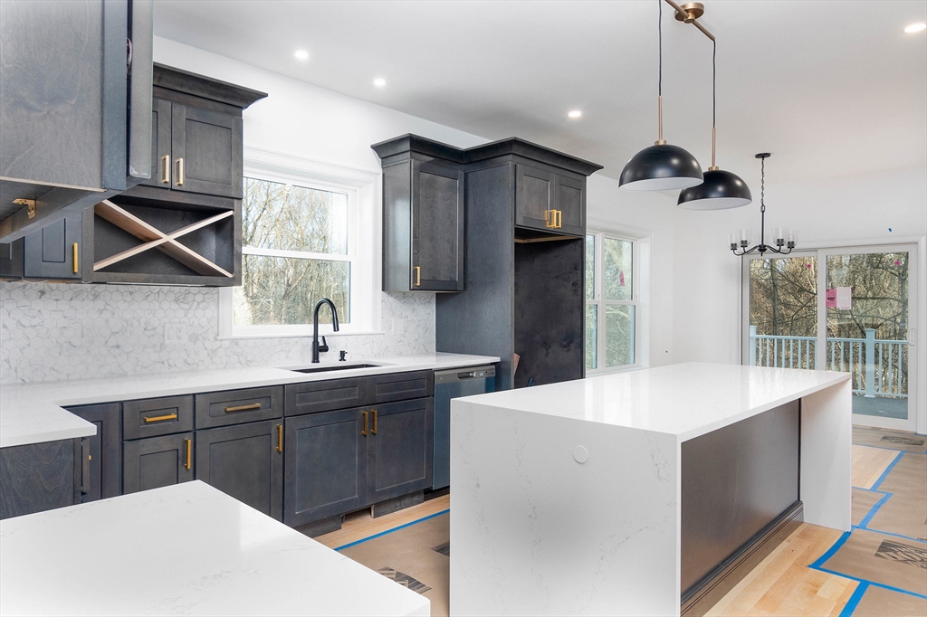 3 Crest Avenue Worcester, MA 01607 - Photo 5 of 34 a kitchen with kitchen island a sink a stove a refrigerator and cabinets