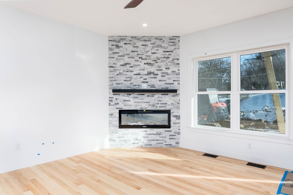 3 Crest Avenue Worcester, MA 01607 - Photo 10 of 34 a view of an empty room with a fireplace and window