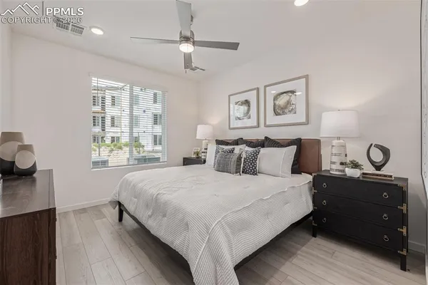 a bedroom with a bed and wooden floor