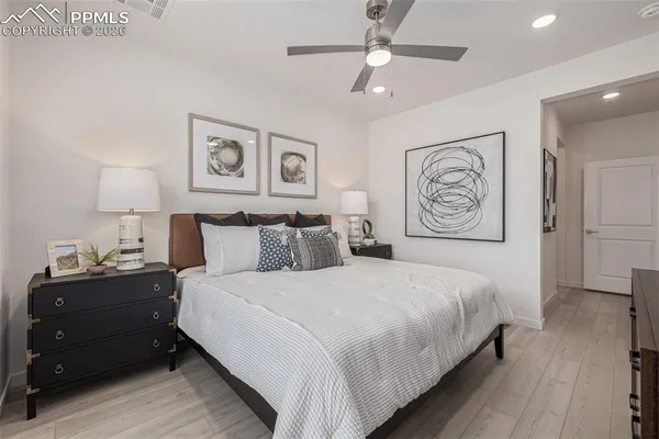 a bedroom with bed and painting on the wall