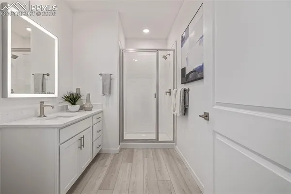 a bathroom with a sink a mirror and a shower