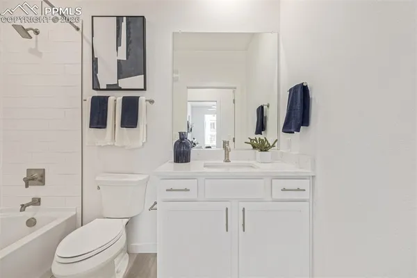 a bathroom with a sink vanity mirror and shower