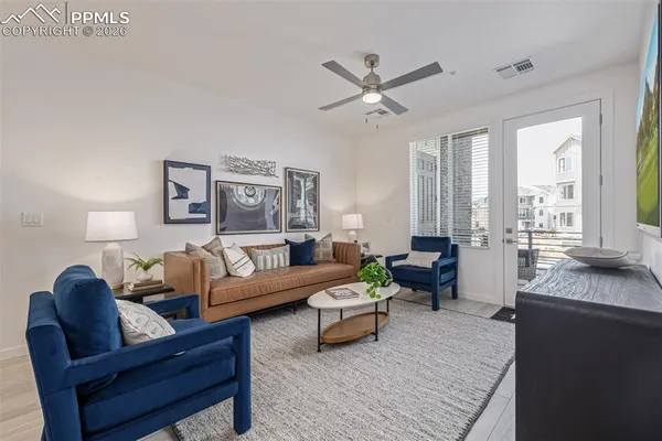 a living room with furniture and a large window