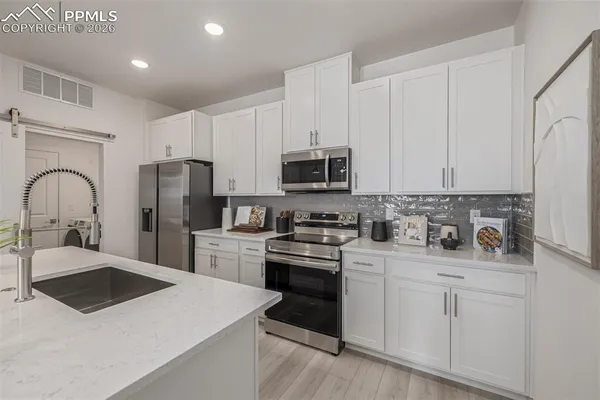 a kitchen with a sink stove and refrigerator