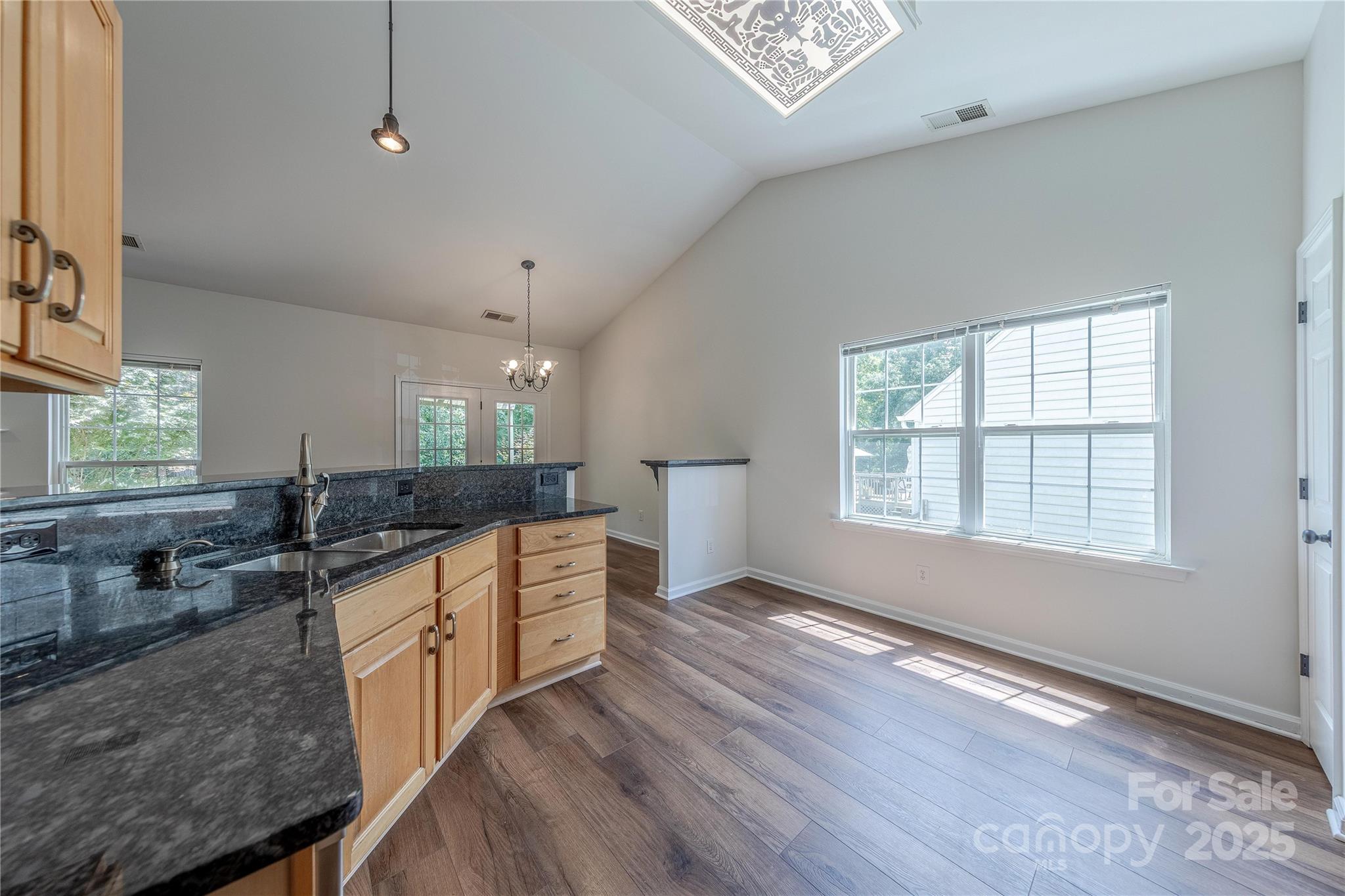 901 Clearbrook Road Matthews, NC 28105 - Photo 14 of 37 a large kitchen with kitchen island granite countertop a sink window and stainless steel appliances