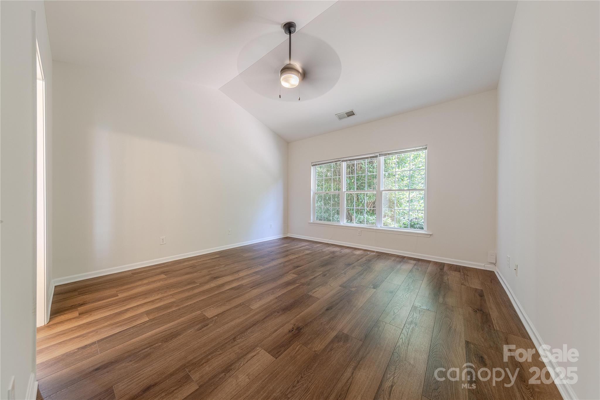 901 Clearbrook Road Matthews, NC 28105 - Photo 15 of 37 an empty room with wooden floor and windows