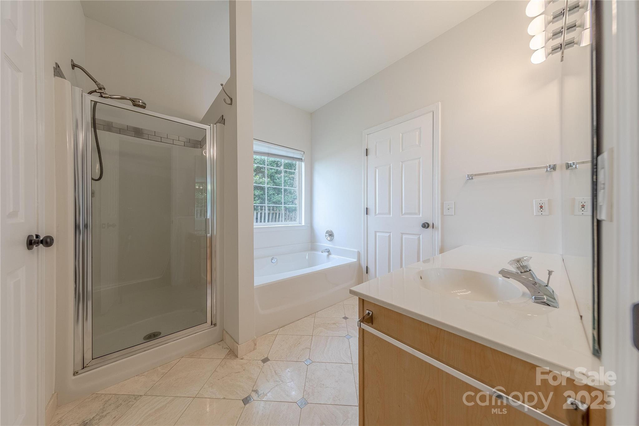 901 Clearbrook Road Matthews, NC 28105 - Photo 19 of 37 a spacious bathroom with a shower and a sink
