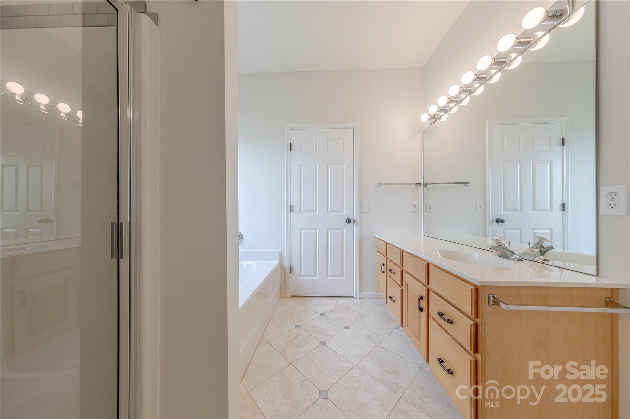 901 Clearbrook Road Matthews, NC 28105 - Photo 20 of 37 a spacious bathroom with a double vanity sink and a mirror