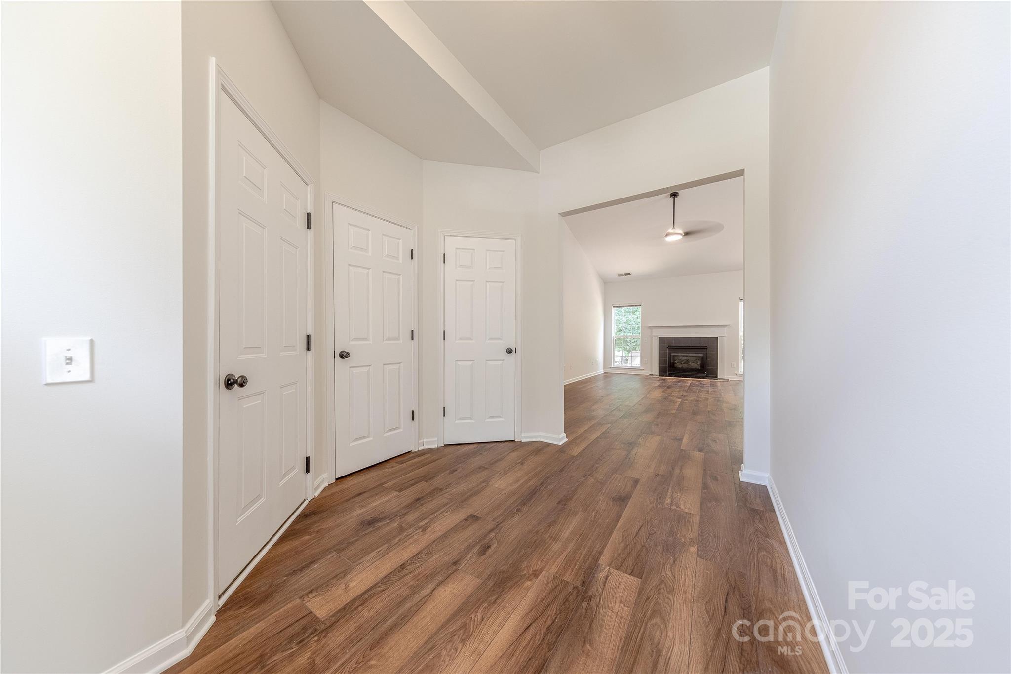 901 Clearbrook Road Matthews, NC 28105 - Photo 3 of 37 a view of empty room with wooden floor and fan