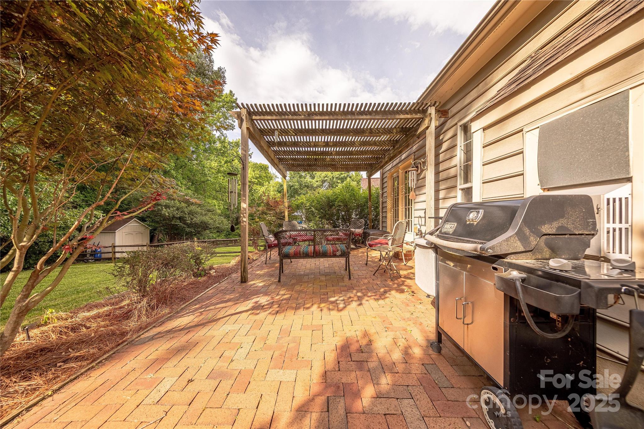 901 Clearbrook Road Matthews, NC 28105 - Photo 31 of 37 a view of a patio with table and chairs next to a yard