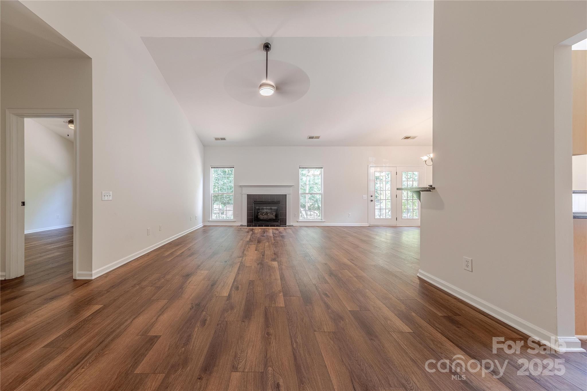 901 Clearbrook Road Matthews, NC 28105 - Photo 4 of 37 a view of empty room with wooden floor and fireplace
