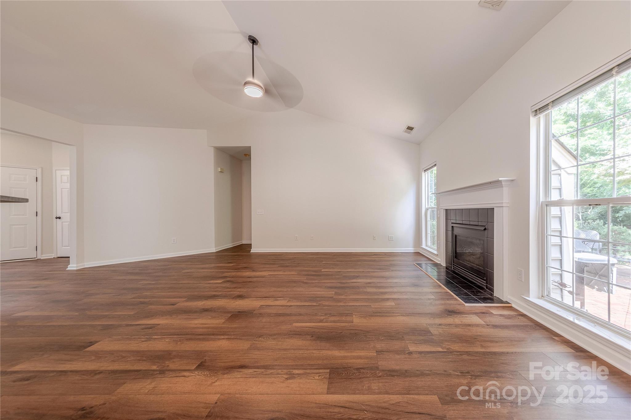 901 Clearbrook Road Matthews, NC 28105 - Photo 6 of 37 a view of an empty room with a fireplace and a window