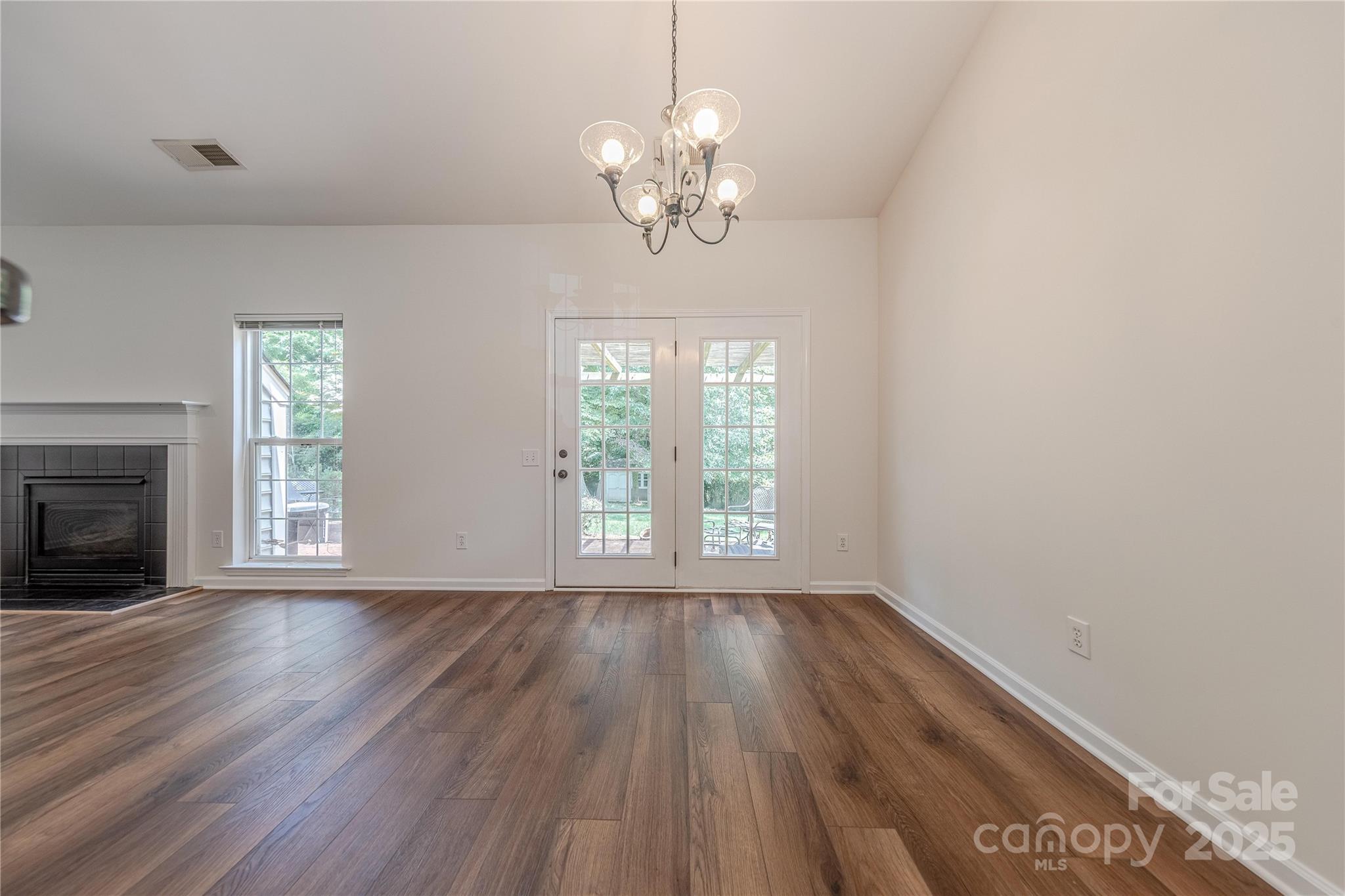 901 Clearbrook Road Matthews, NC 28105 - Photo 7 of 37 a view of an empty room with wooden floor and a window