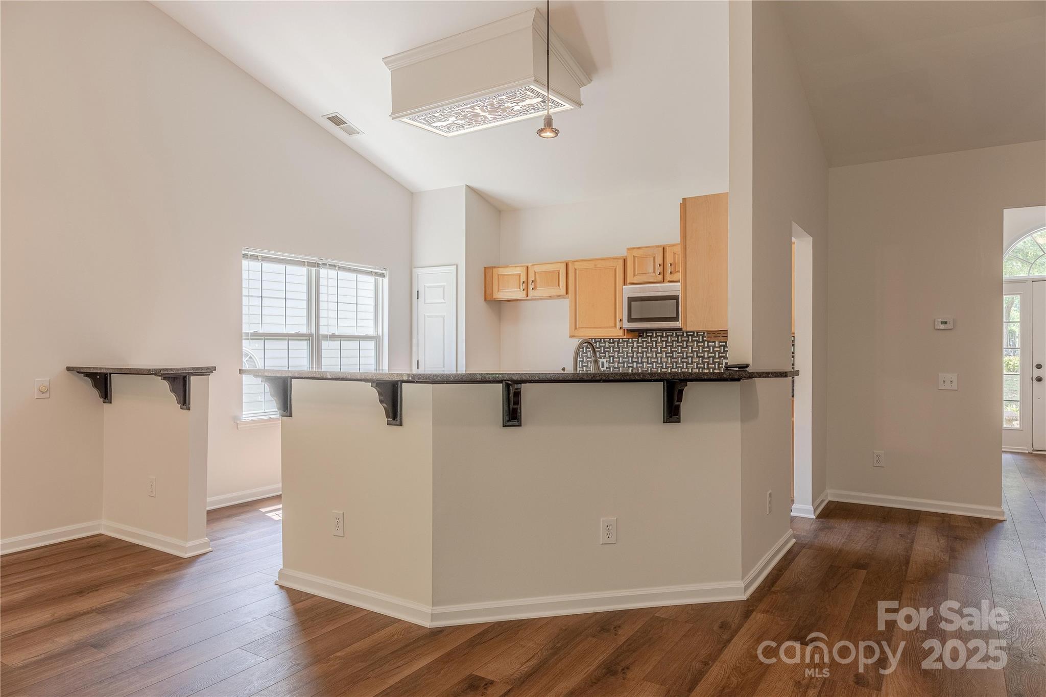 901 Clearbrook Road Matthews, NC 28105 - Photo 9 of 37 a view of a kitchen with furniture and wooden floor
