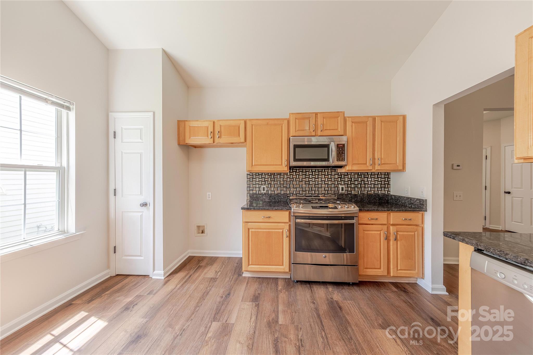 901 Clearbrook Road Matthews, NC 28105 - Photo 10 of 37 a kitchen with stainless steel appliances granite countertop a stove a sink and a refrigerator