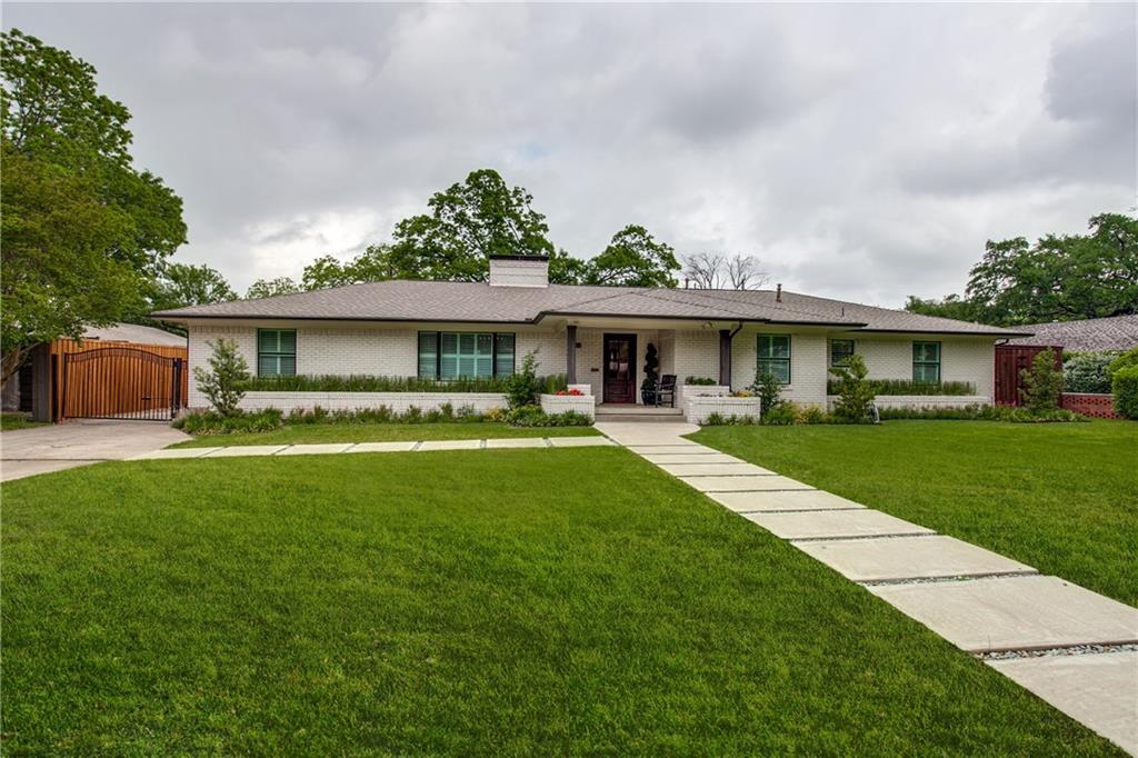 6015 Boca Raton Drive Dallas, TX 75230 - Photo 1 of 1 a front view of a house with a yard table and chairs