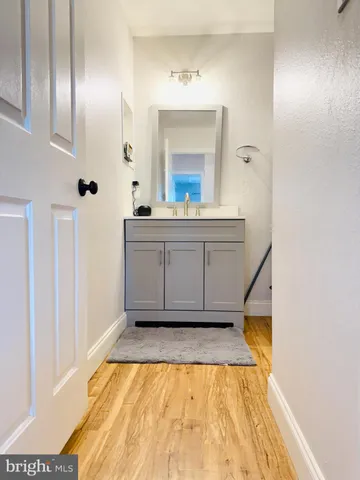 a bathroom with a sink mirror and vanity