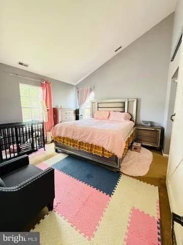 a bedroom with a bed couch and a window