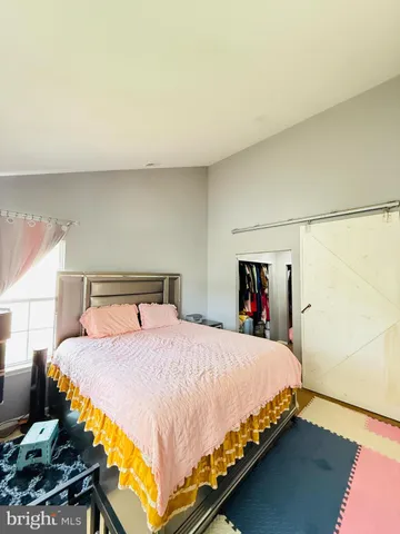 a bedroom with a bed and dresser