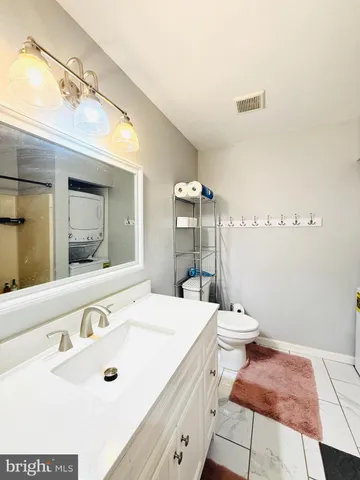 a bathroom with a sink a toilet and mirror