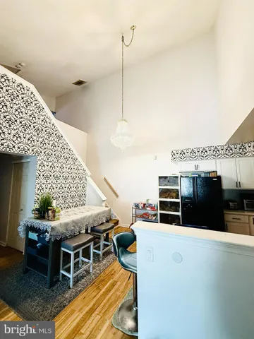 a living room with a table tennis table and chairs