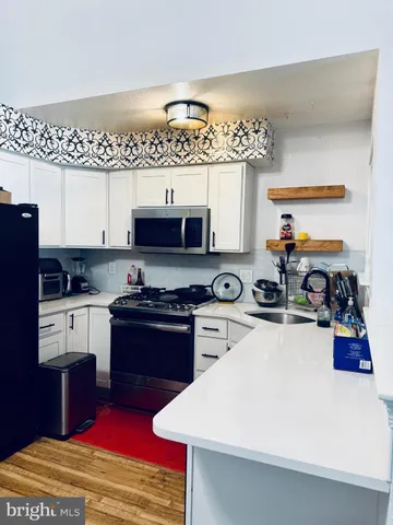 a kitchen with stainless steel appliances and a refrigerator