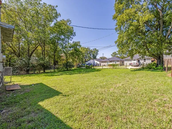 a view of yard with swimming pool and green space