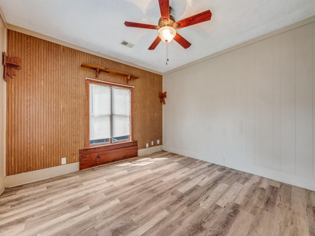 609 East Monterey Street Denison, TX 75021 - Photo 3 of 12 wooden floor in an empty room with a window