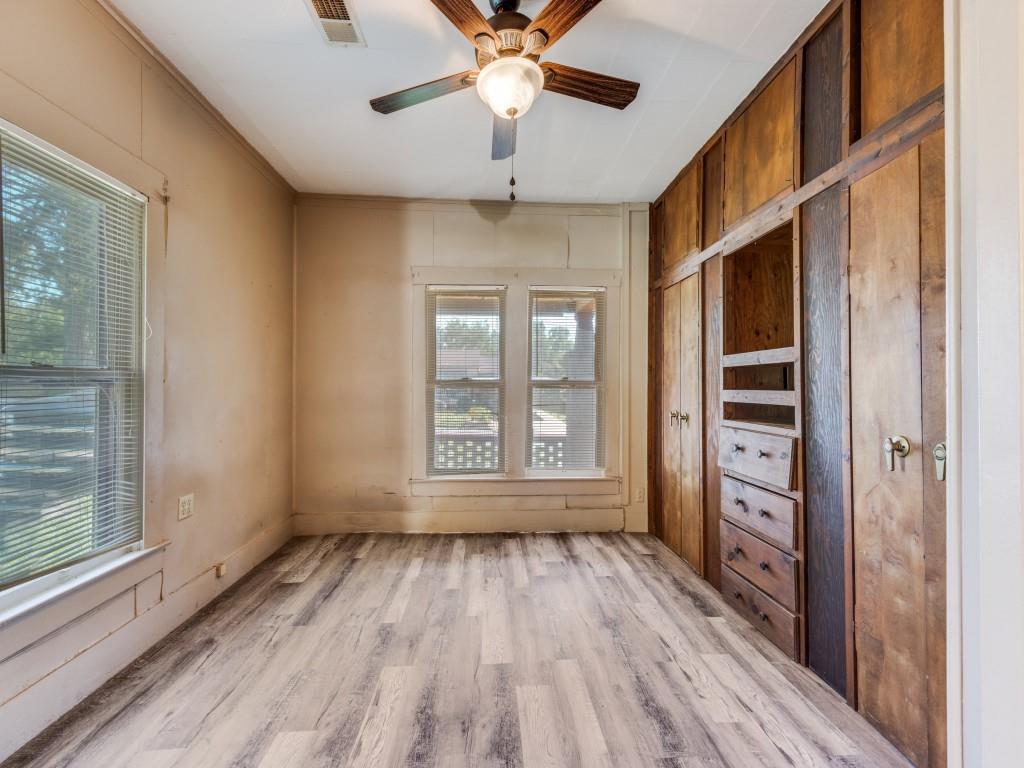 609 East Monterey Street Denison, TX 75021 - Photo 5 of 12 a view of an empty room with a window and wooden floor