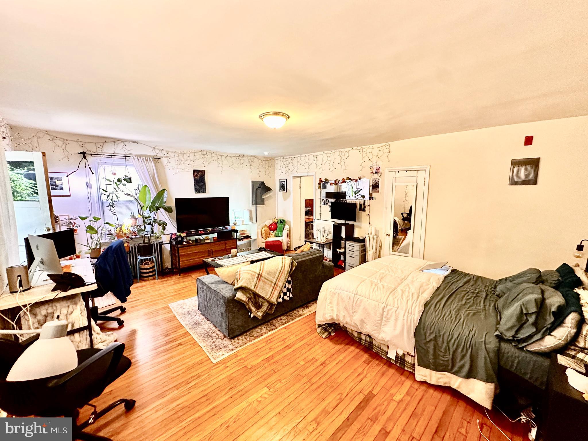 243 West Rittenhouse Street, Unit 2C Philadelphia, PA 19144 - Photo 3 of 9 a bedroom with two beds and a couch