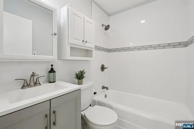 a bathroom with a sink a toilet and bathtub
