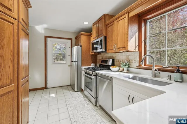 a kitchen with a sink cabinets and appliances
