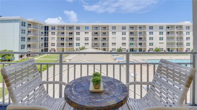 a view of a balcony with chairs