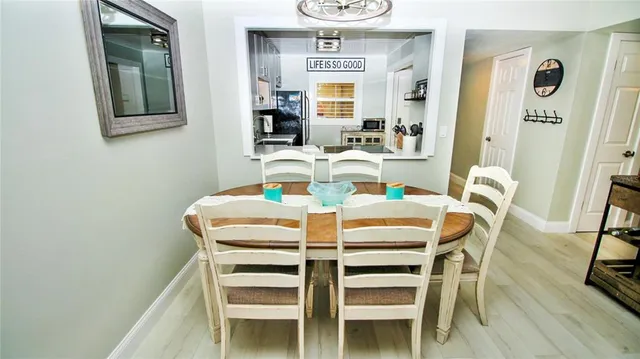 a dining room with furniture and wooden floor