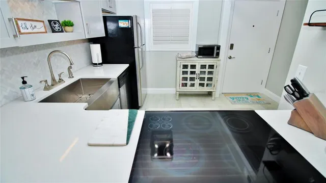 a view of a kitchen sink and a microwave