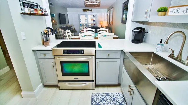 a kitchen with a stove a sink and a refrigerator