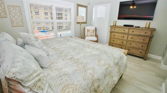 a bedroom with a bed and a flat screen tv