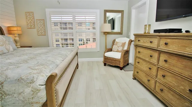 a spacious bedroom with a bed and a couch