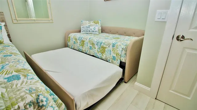 a bed sitting in a bedroom next to a window