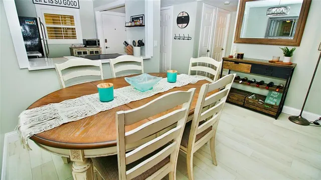 a dining room with furniture and a window