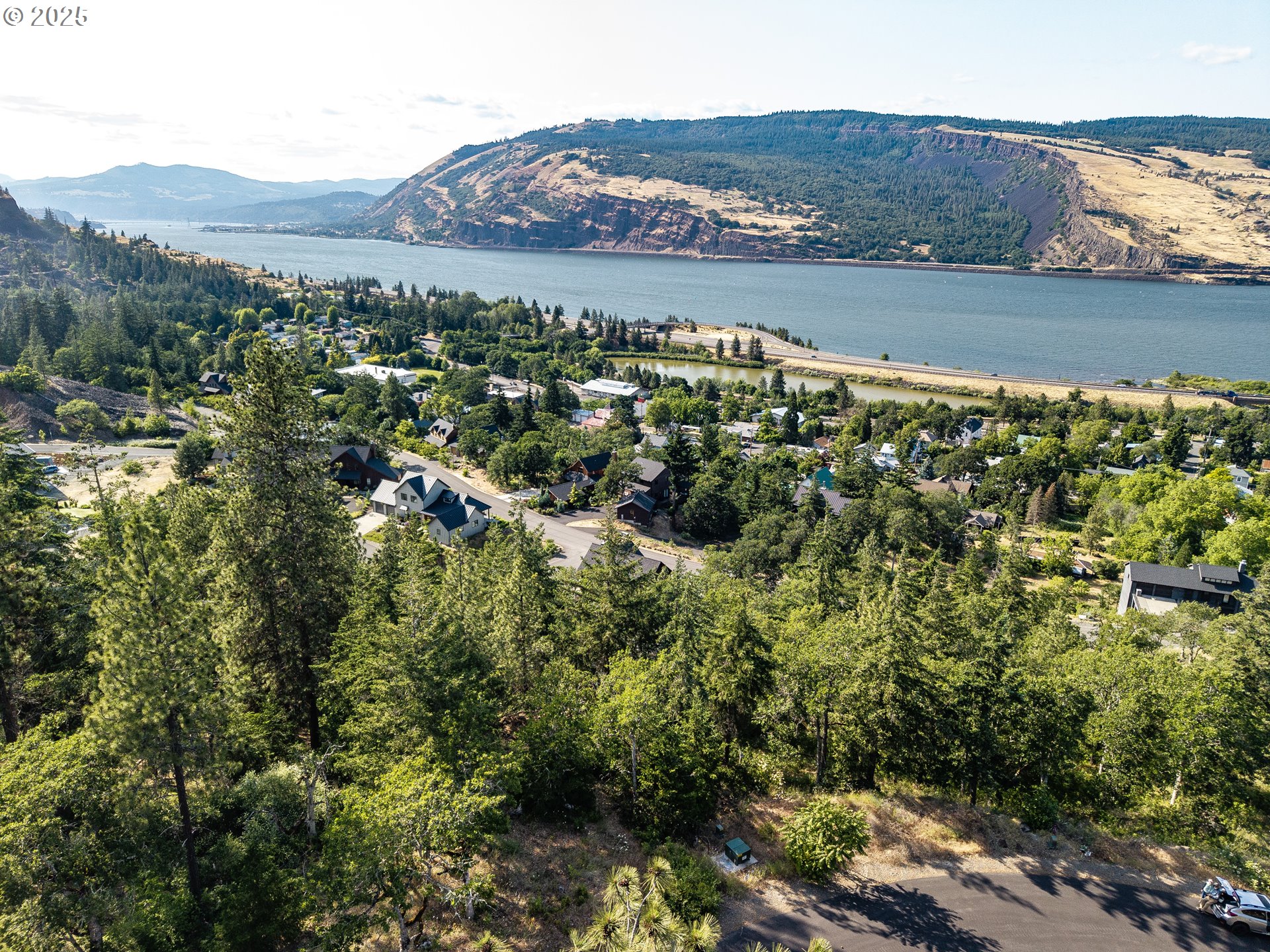 Coyote Court, Unit 44 Mosier, OR 97040 - Photo 1 of 10 a view of a lake with mountains in the background