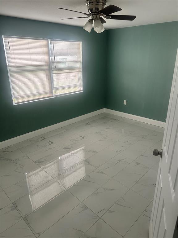 6740 Dairy Road Zephyrhills, FL 33542 - Photo 6 of 8 a view of a livingroom with an empty space and a window