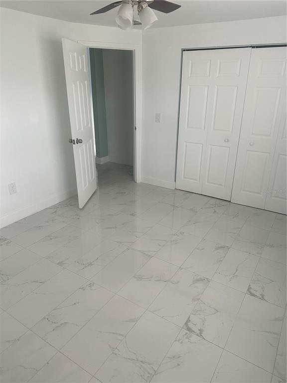 6740 Dairy Road Zephyrhills, FL 33542 - Photo 7 of 8 an empty room with a natural light