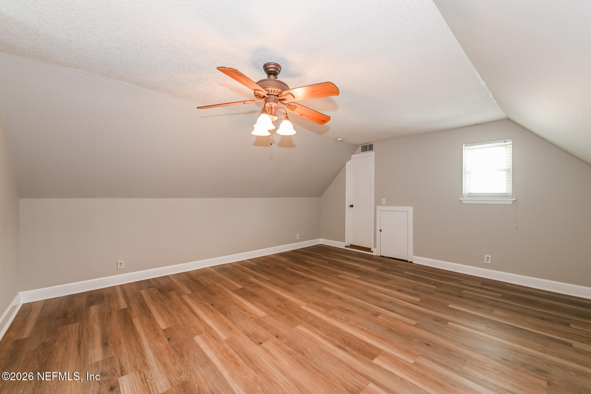 1077 Kings Road Neptune Beach, FL 32266 - Photo 14 of 19 an empty room with a chandelier fan and windows