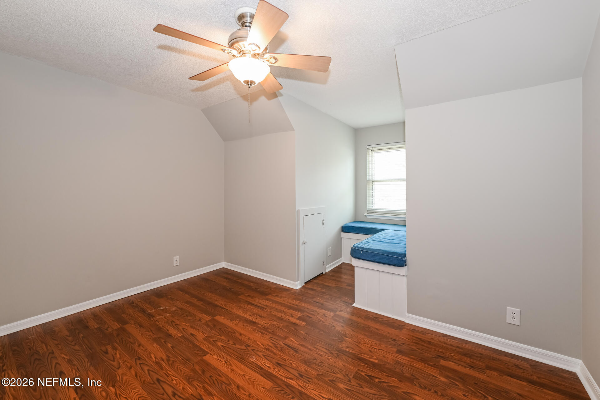 1077 Kings Road Neptune Beach, FL 32266 - Photo 16 of 19 an empty room with wooden floor and fan